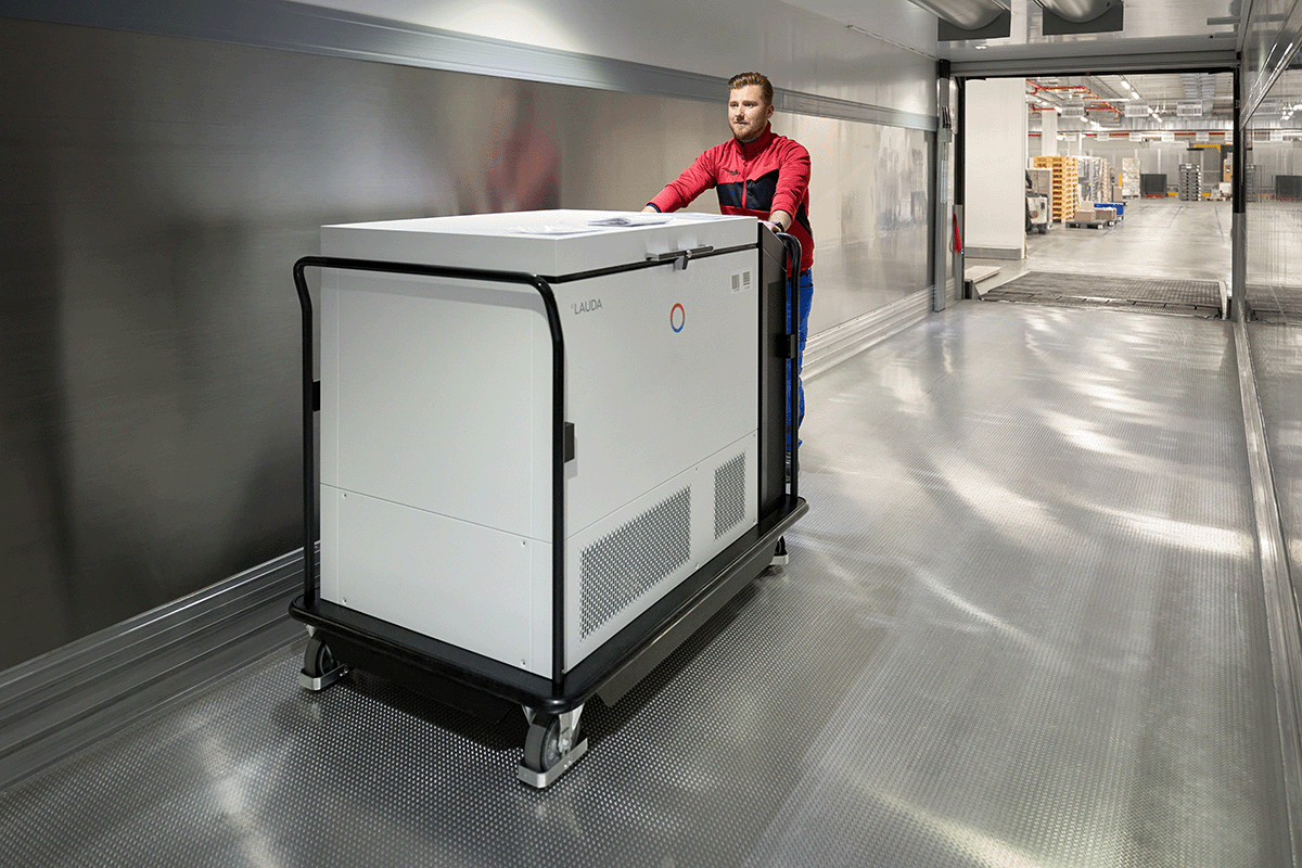 Worker transporting the mobile freezer, developed for internal API transport