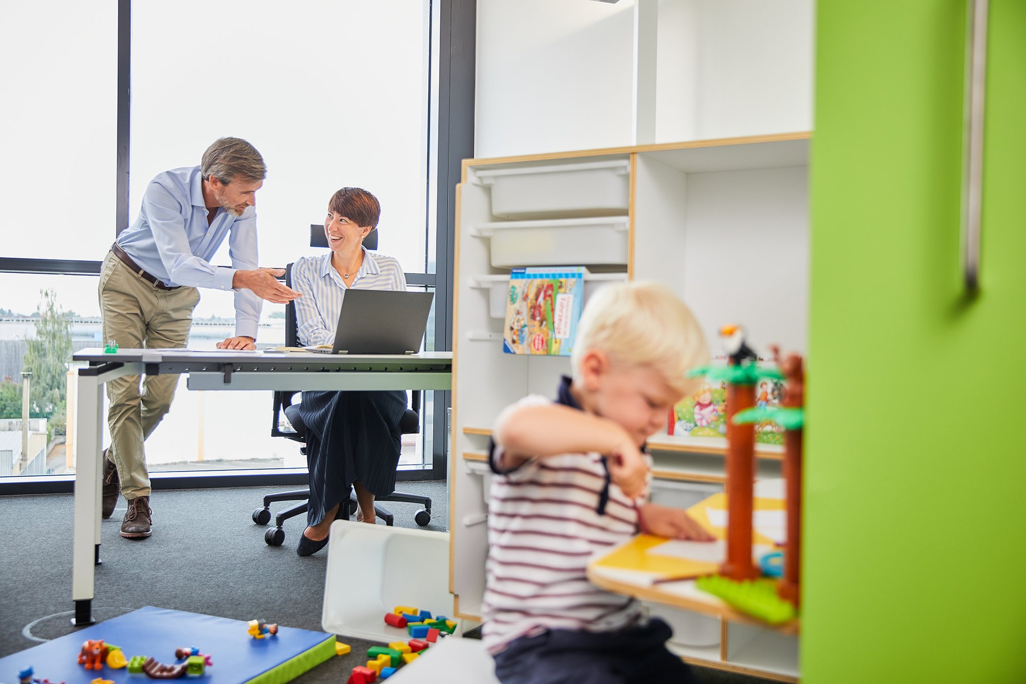 Working in the Parent Office while child plays